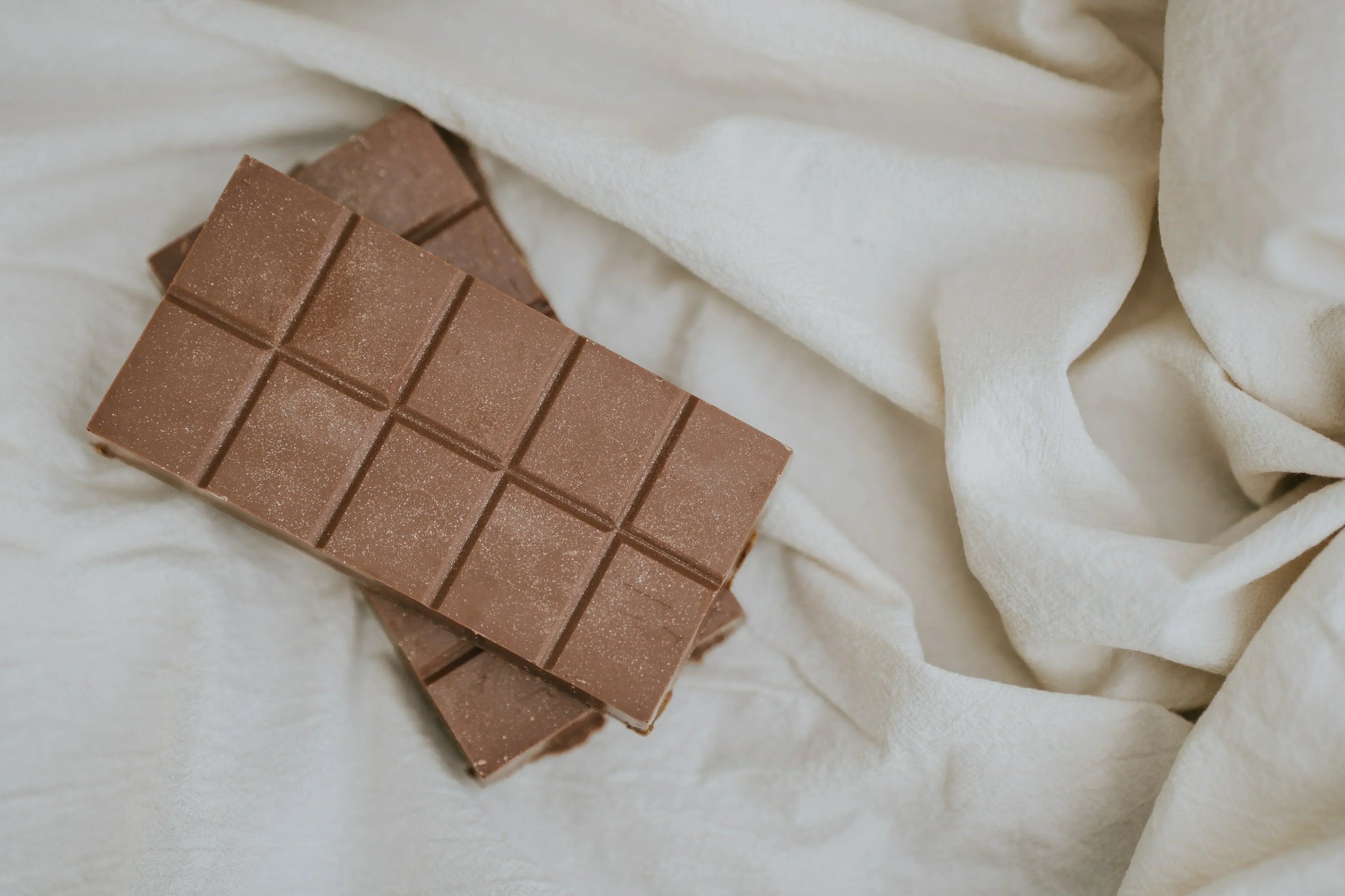 Chocolate bars on a white fabric background