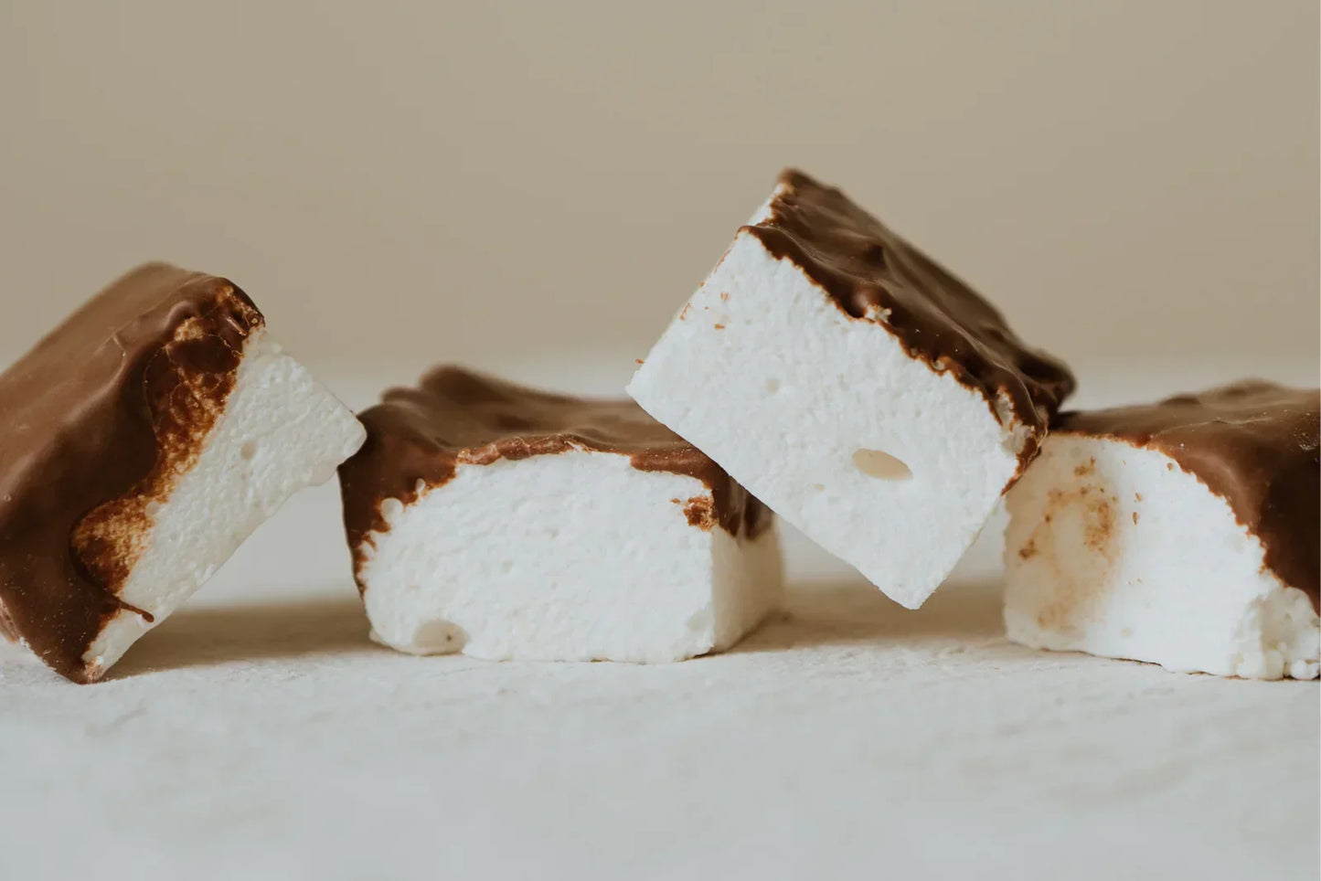 Coffee Marshmallows with chocolate coating on a light background