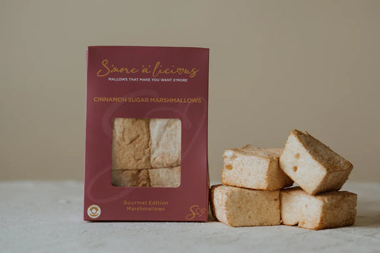 Box of cinnamon sugar marshmallows with marshmallows on a neutral background