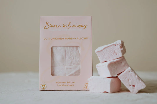 Pink cotton candy marshmallows with packaging on a light background