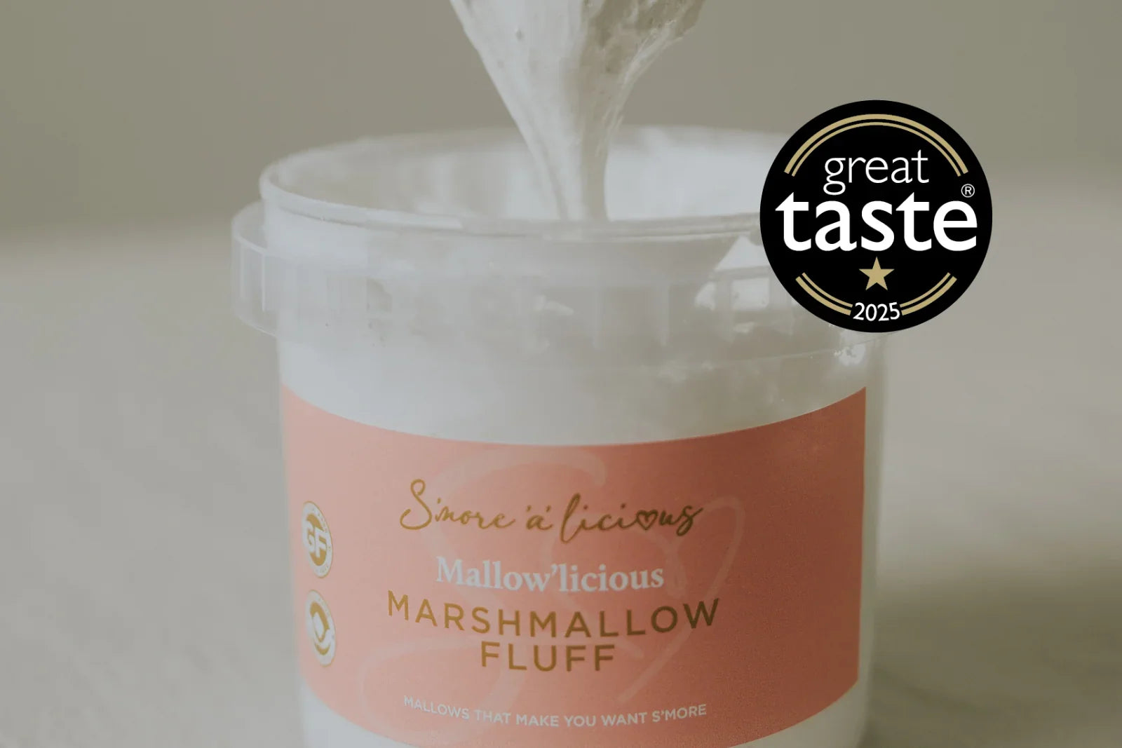 Jar of marshmallow fluff with 'Great Taste' award logo on a neutral background