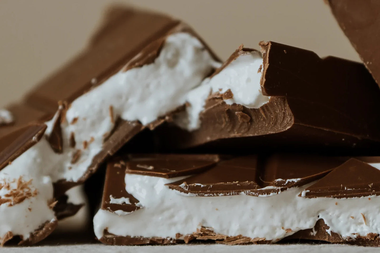 Close-up of chocolate bars with marshmallow filling on a neutral background